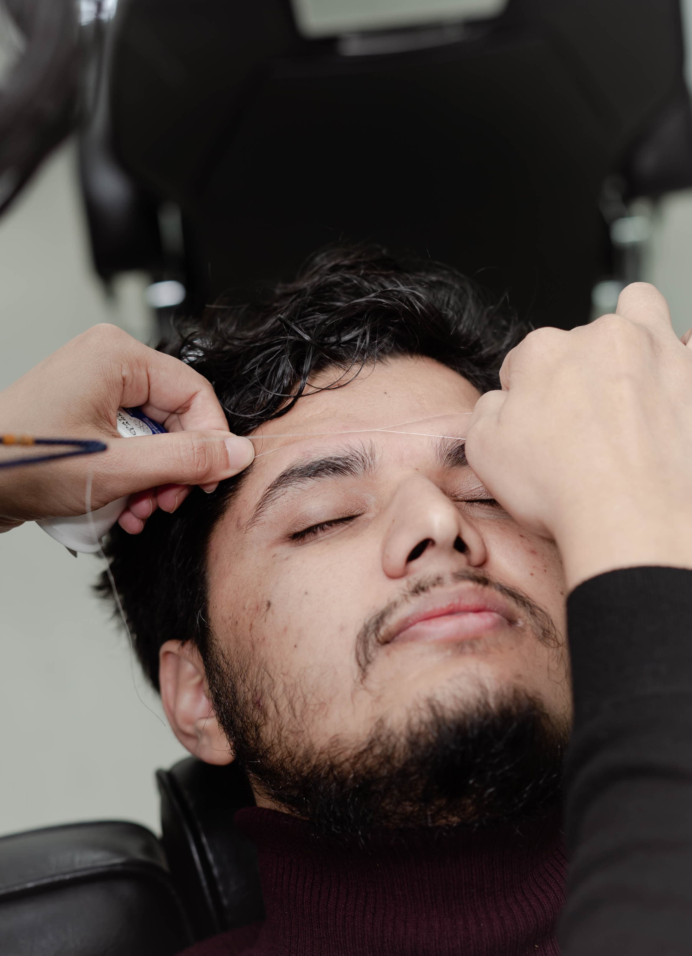 Eyebrow threading close-up — clean precise result